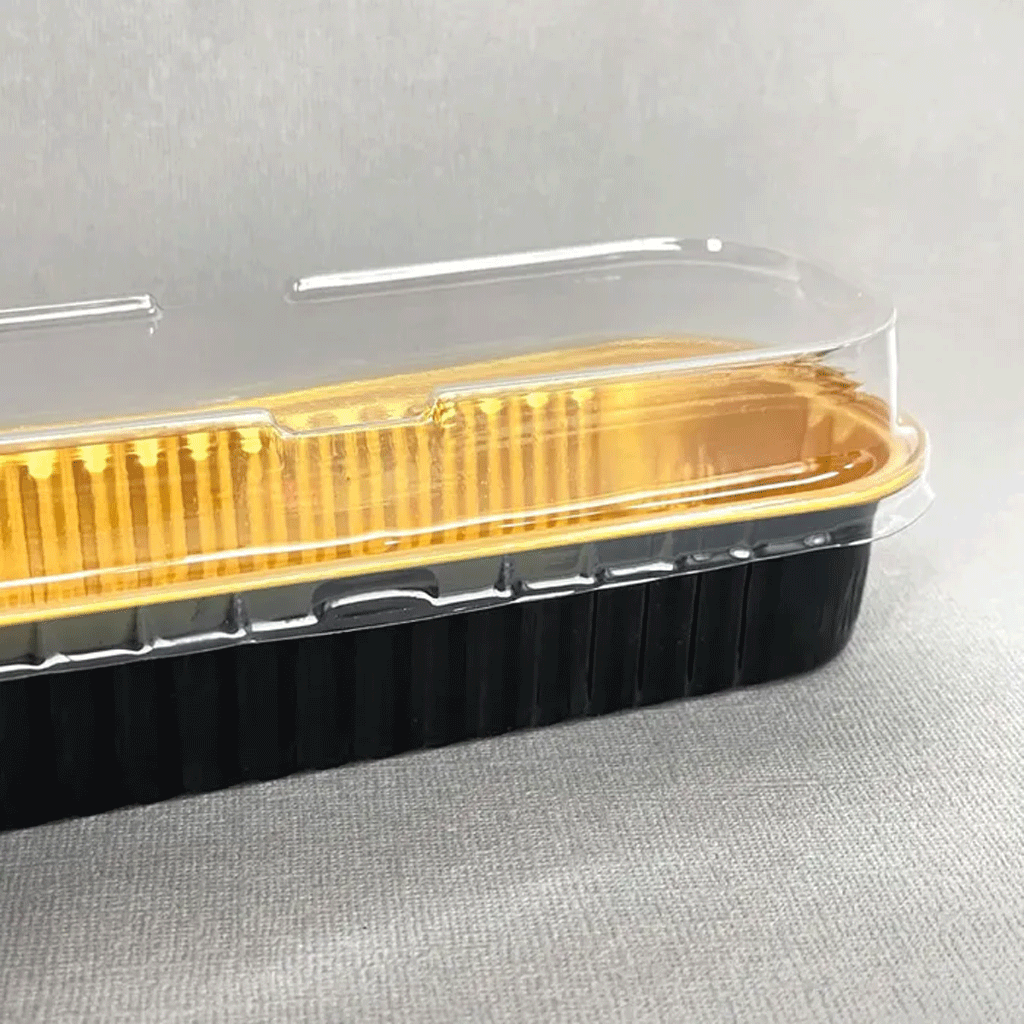 black and gold foil baking cup with clear plastic lid on top