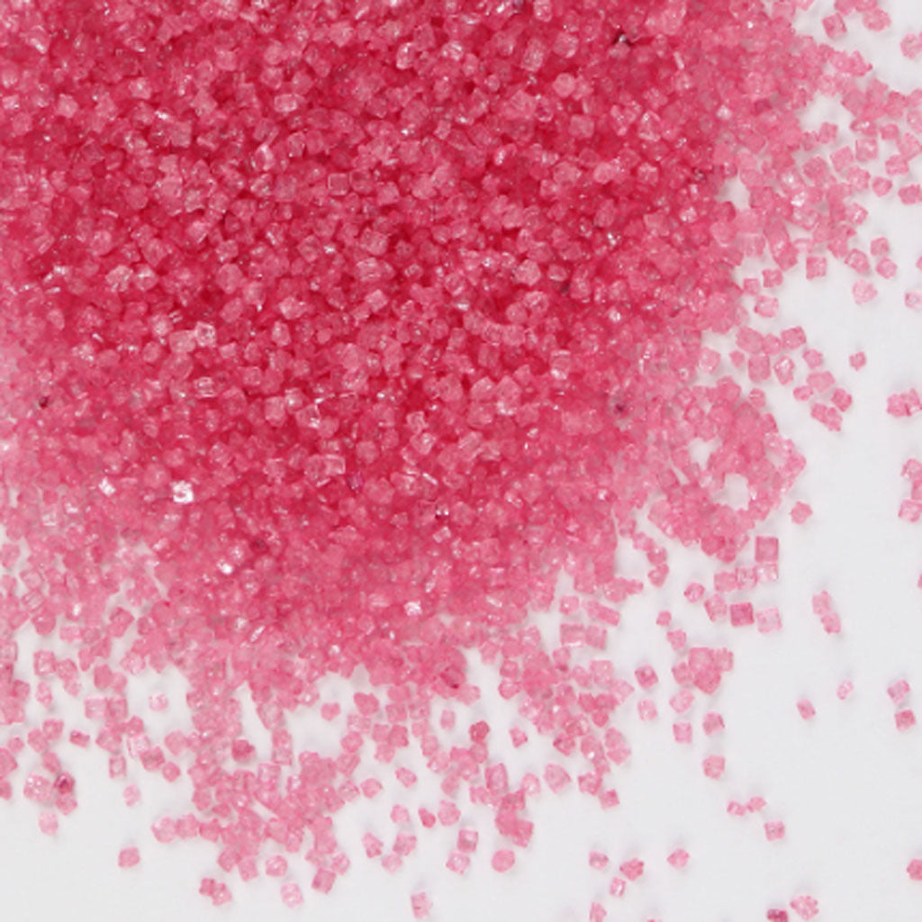 Gobake natural pink crystal sugar product dispersed on a surface.