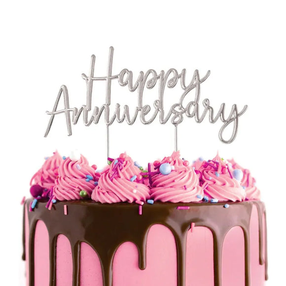 Cake Craft Happy Anniversary Silver Metal Topper placed on a pink cake with chocolate brown cake drip and scattered with sprinkles