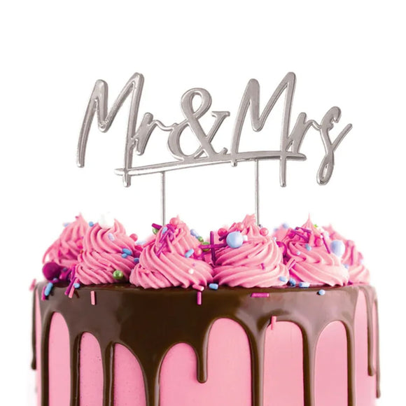 Cake Craft Mr & Mrs Silver Metal Cake Topper placed on a pink cake with chocolate cake drip