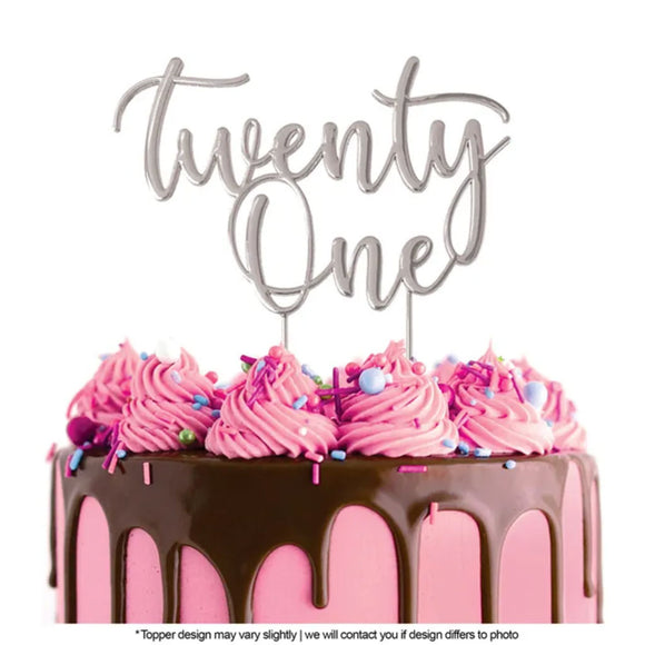 Cake Craft Twenty One Silver Metal Cake Topper placed on a pink cake with chocolate cake drip
