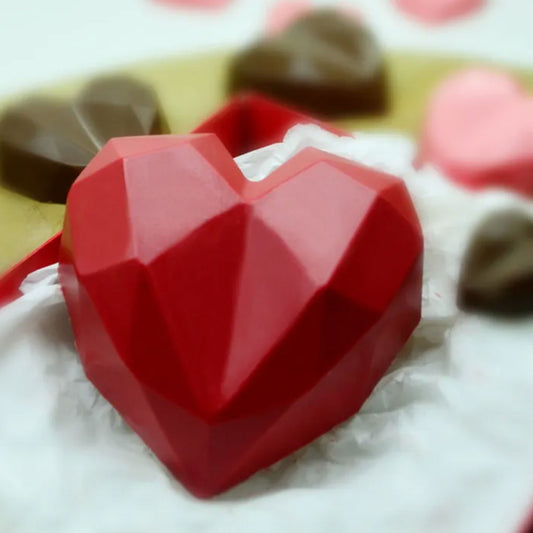 Red Chocolate Geo Heart in red gift box surrounded by smaller geo hearts