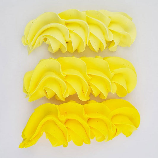 buttercream colour examples of the canary yellow gel colour on a white background