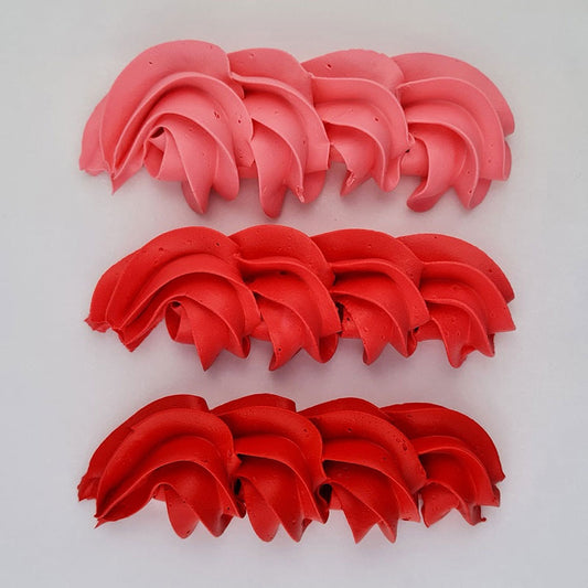 buttercream colour examples of the Christmas red gel colour on a white background
