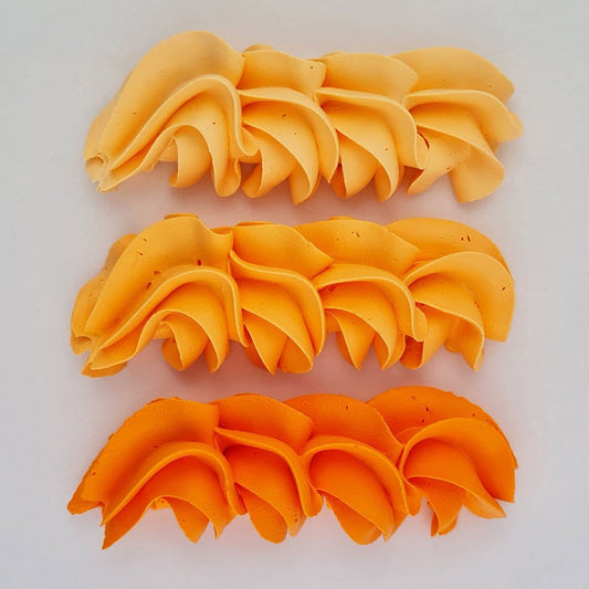 buttercream colour examples of the dahlia orange gel colour on a white background