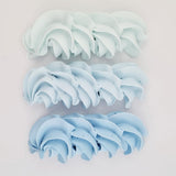buttercream colour examples of the duck egg blue gel colour on a white background