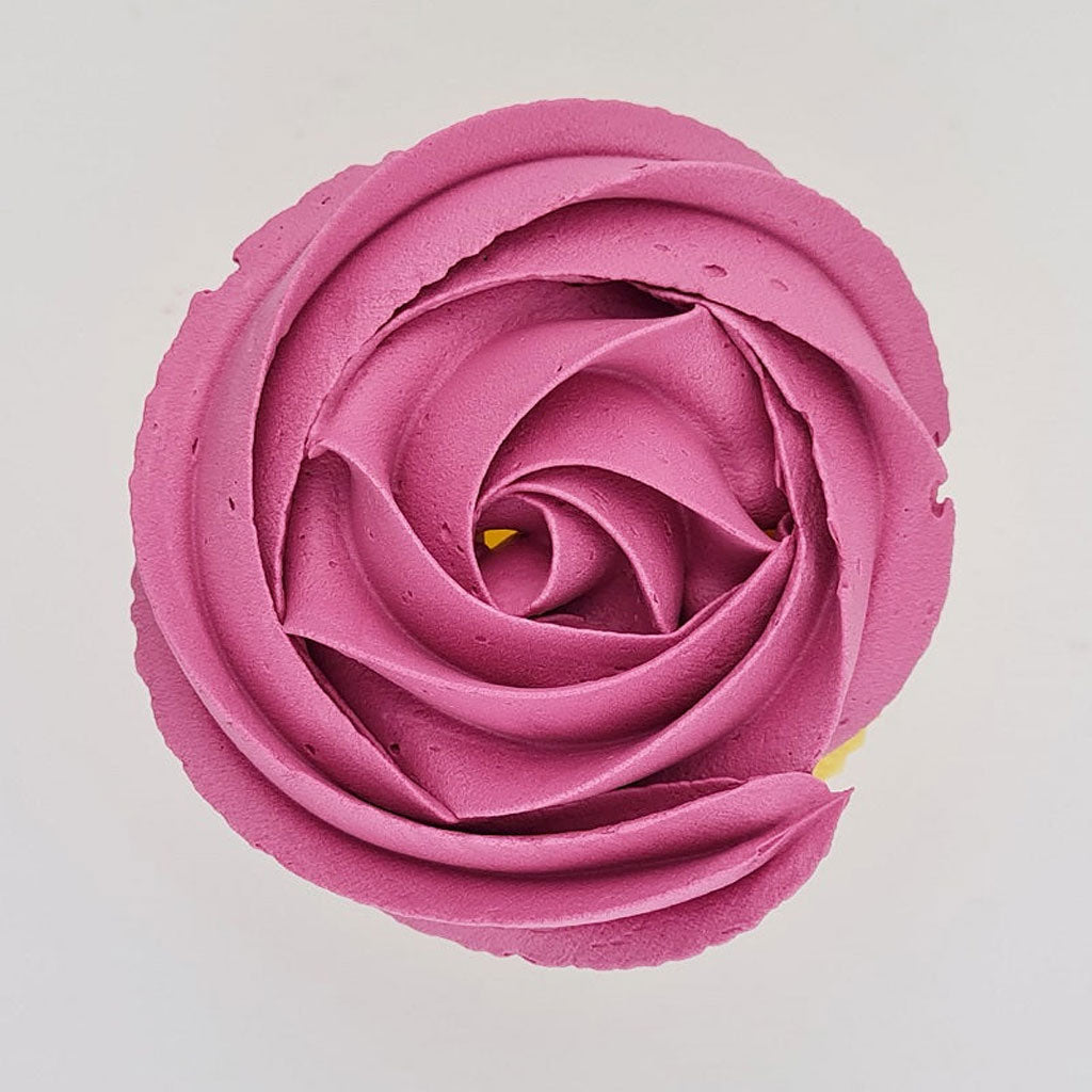 pink buttercream rose piped on to a muffin using the gobake fuchsia pink gel colour