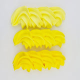 buttercream colour examples of the neon yellow gel colour on a white background