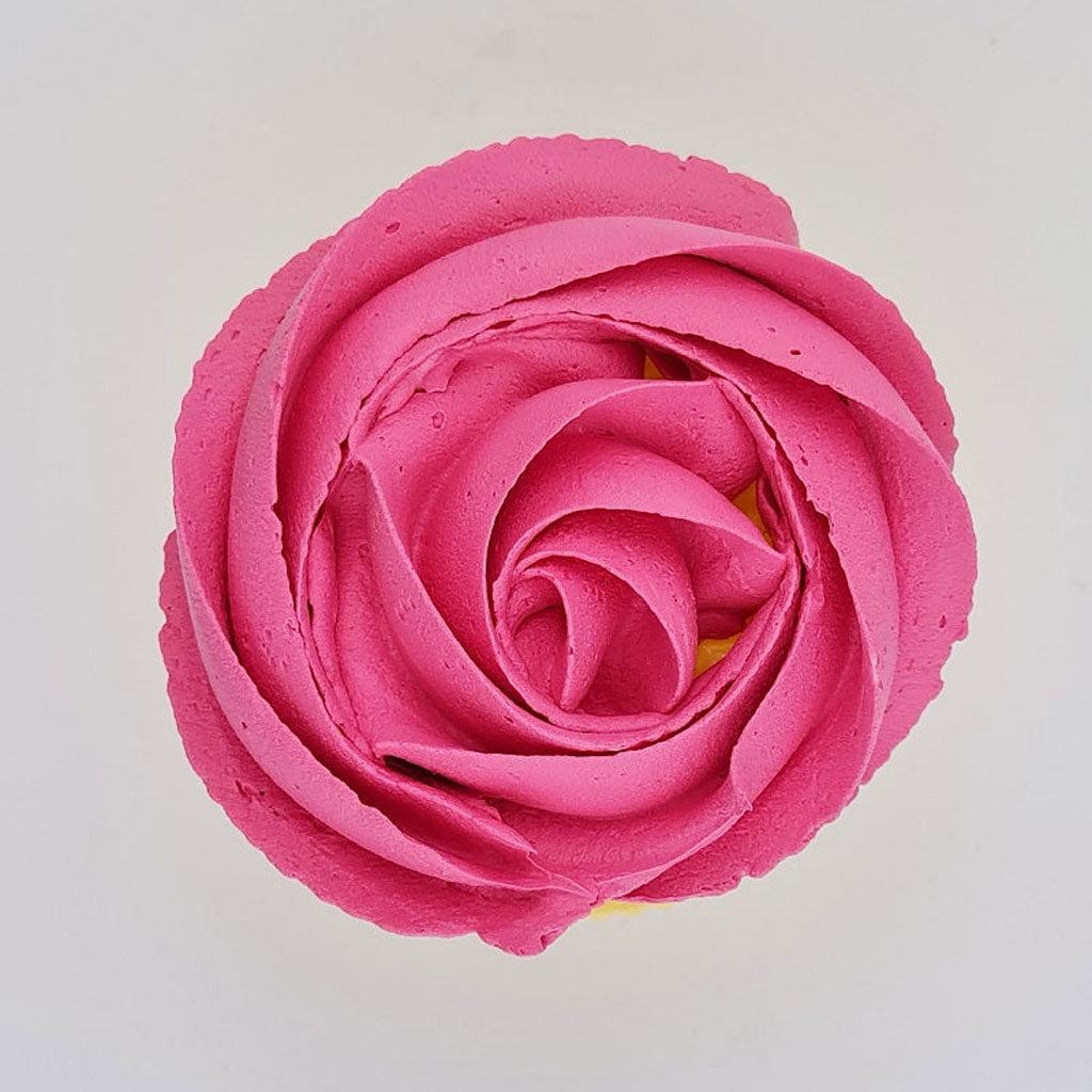 pink buttercream rose piped on to a muffin using the gobake pink Charlotte gel colour