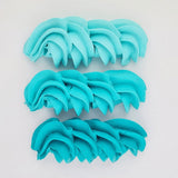 buttercream colour examples of the teal gel colour on a white background