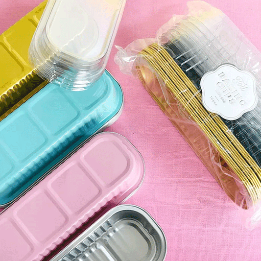 foil rectangle coloured baking cups upside down on a pink background
