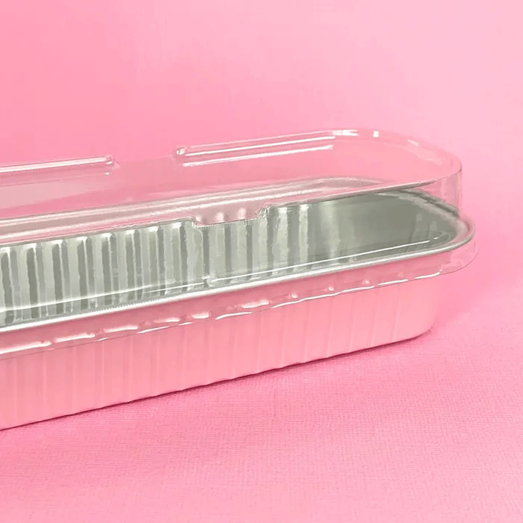 pink and silver foil rectangle baking cup with clear plastic lid on top 