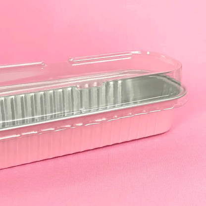 pink and silver foil rectangle baking cup with clear plastic lid on top 