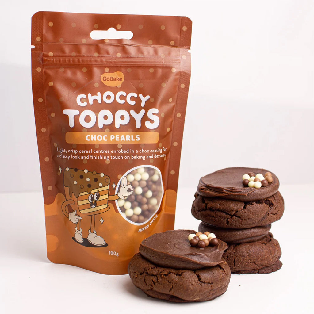 Packaging of Choccy Toppys Choc Pearls with chocolate cookies decorated with the choc pearls on a white background