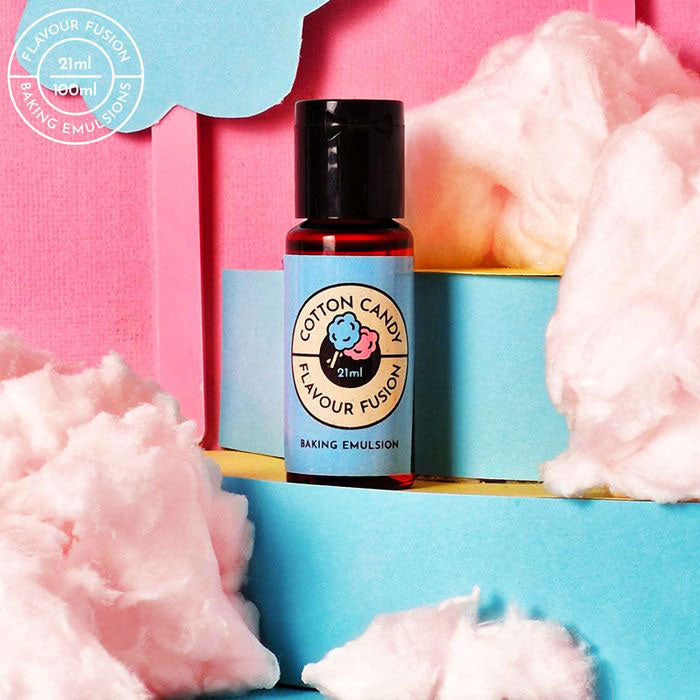 cotton candy flavoring in blue bottle surrounded by clouds of cotton candy