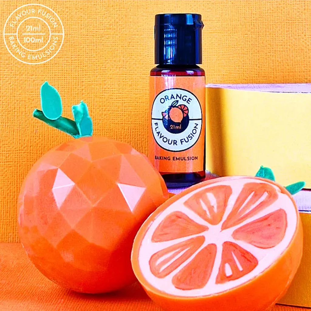 A bottle of Vivid Orange Flavour Fusion beside chocolate candy oranges with an orange background