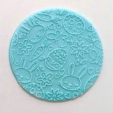 bunny & egg pattern from debosser on round circle of blue fondant
