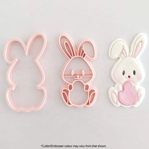 bunny with egg cookie cutter, embosser and white bunny icing example laid out side by side