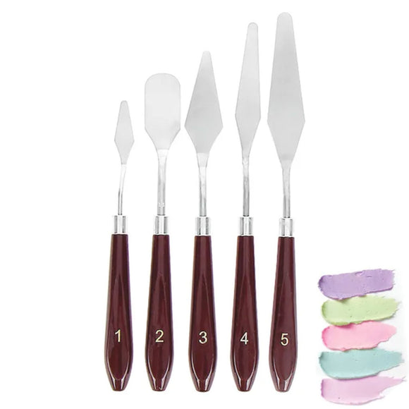 5 stainless steel buttercream palette knives with plastic handles beside buttercream