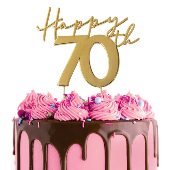 Cake Craft Happy 70th Gold Metal Cake Topper placed on a pink cake with chocolate cake drip