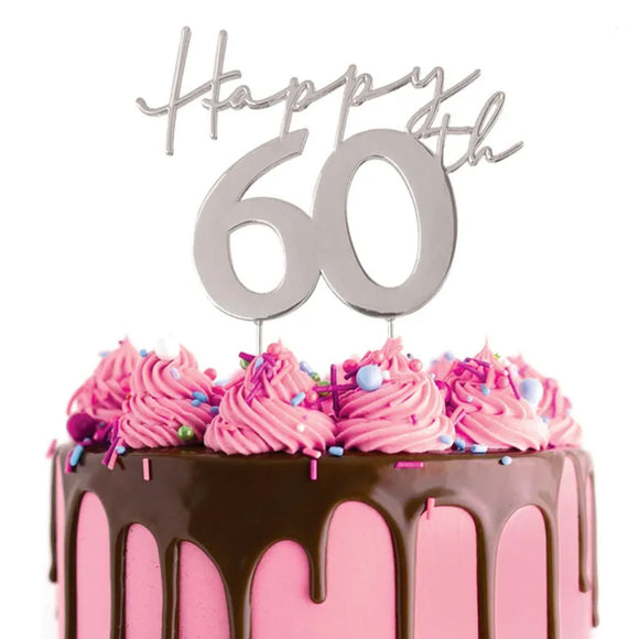 Cake Craft Happy 60th Silver Metal Cake Topper placed on a pink cake with chocolate cake drip