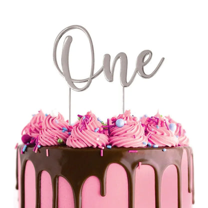 Cake Craft One Silver Metal Cake Topper placed on a pink cake with chocolate cake drip