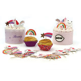 cakes and cupcakes decorated with unicorns and rainbows and stars with cupcake toppers scattered in front