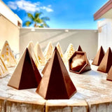 milk and white chocolate 6 sided pyramids sitting on barrel 