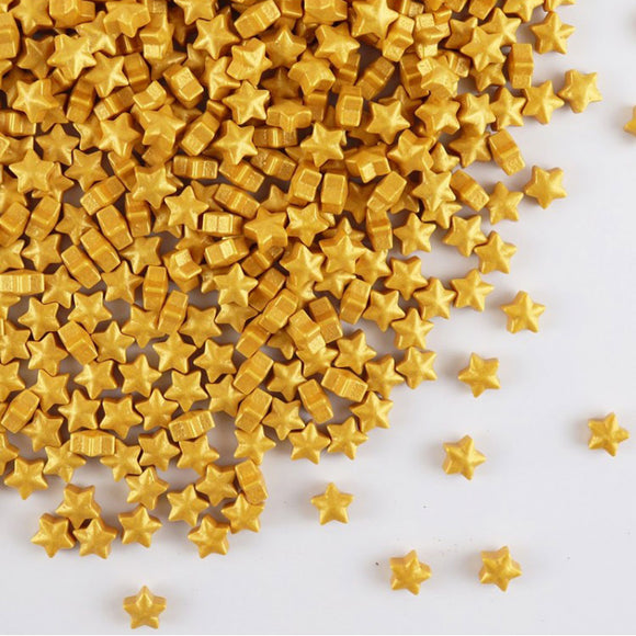 gold star shaped sprinkles scattered on a white background