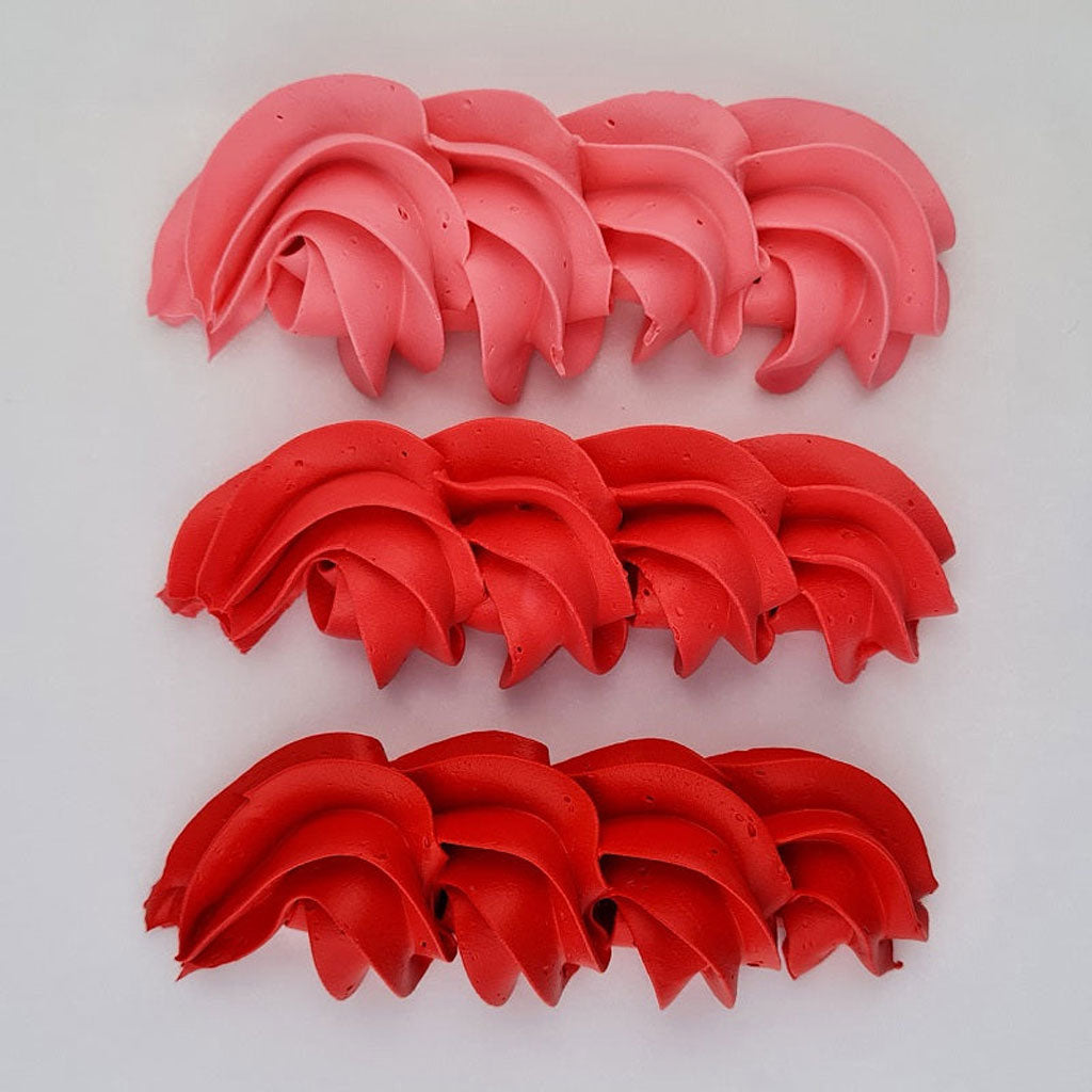 buttercream colour examples of the Christmas red gel colour on a white background