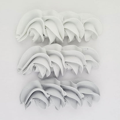 buttercream colour examples of the concrete grey gel colour on a white background