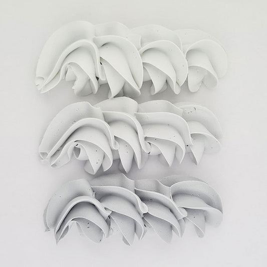 buttercream colour examples of the concrete grey gel colour on a white background