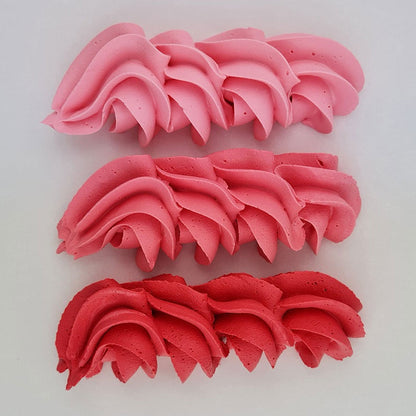 buttercream colour examples of the coral pink gel colour on a white background