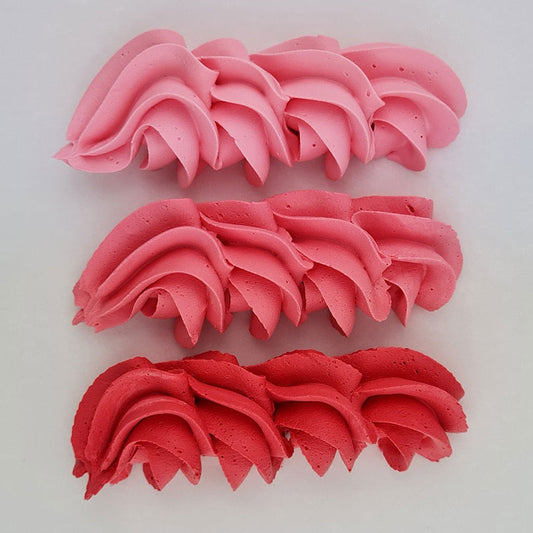 buttercream colour examples of the coral pink gel colour on a white background