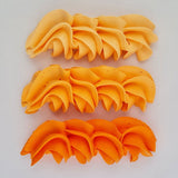 buttercream colour examples of the dahlia orange gel colour on a white background