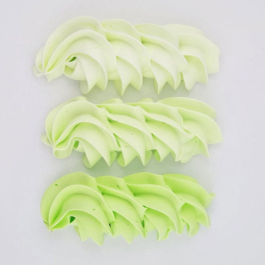 buttercream colour examples of the green apple gel colour on a white background