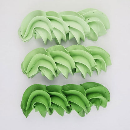buttercream colour examples of the moss green gel colour on a white background