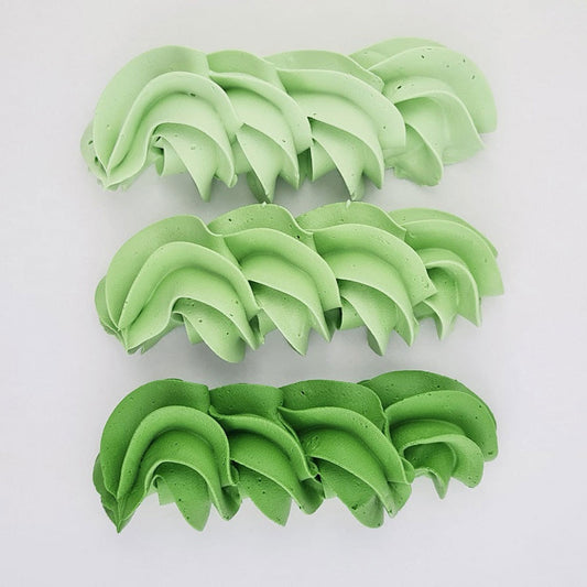 buttercream colour examples of the moss green gel colour on a white background