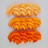 buttercream colour examples of the neon orange gel colour on a white background