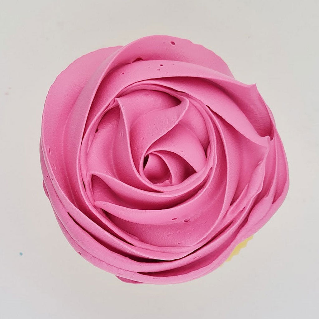pink buttercream rose piped on to a muffin using the gobake neon pink gel colour
