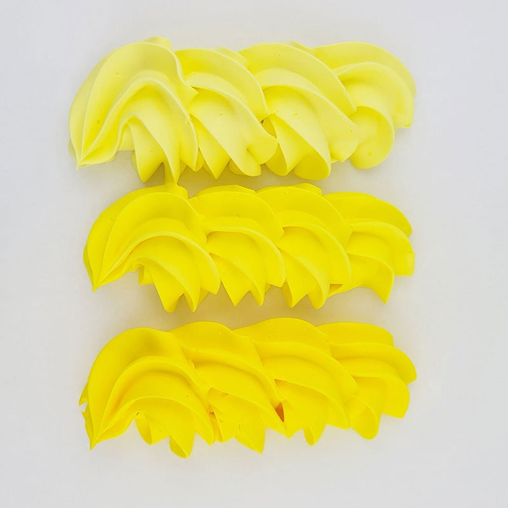 buttercream colour examples of the neon yellow gel colour on a white background