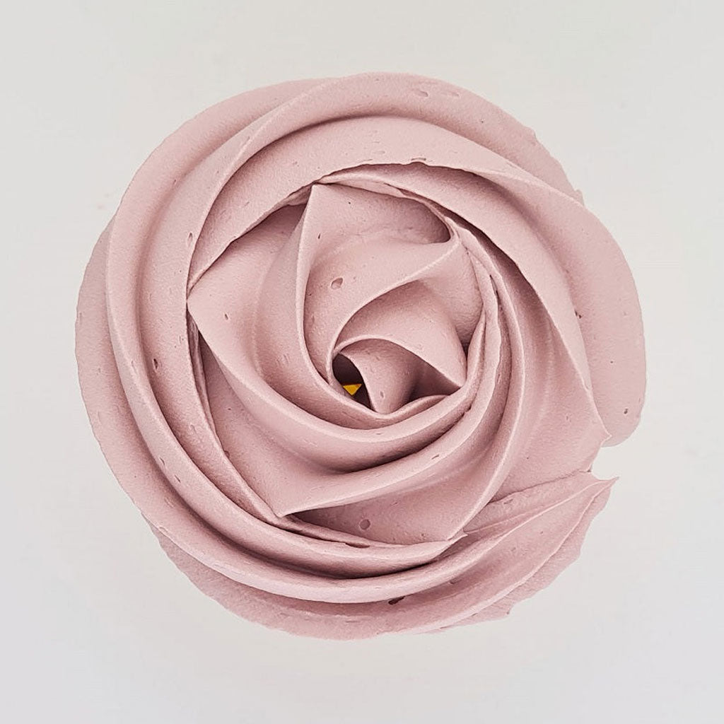 pink buttercream rose piped on to a muffin using the gobake rose quartz gel colour