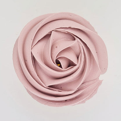 pink buttercream rose piped on to a muffin using the gobake rose quartz gel colour