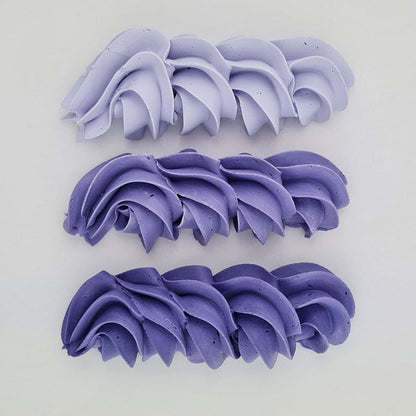 buttercream colour examples of the violet gel colour on a white background