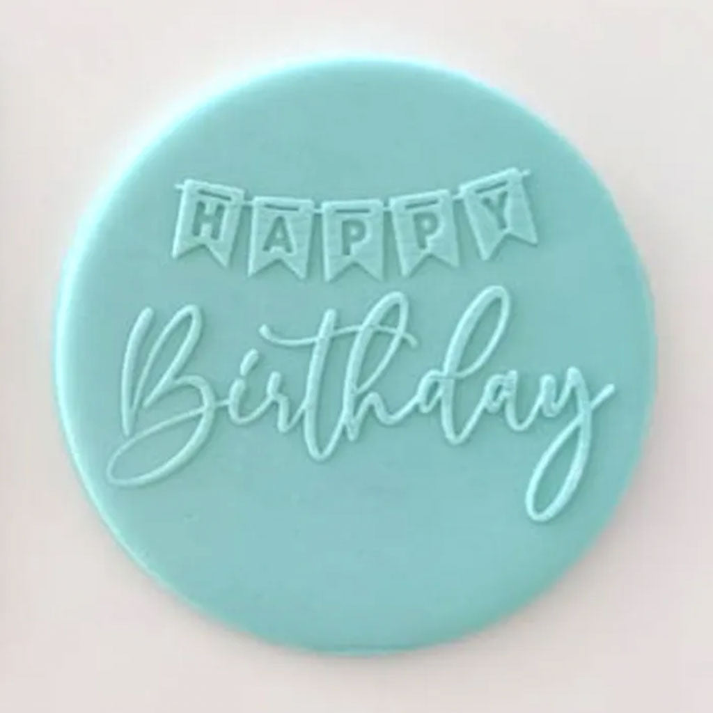 Happy Birthday banner pattern from debosser on round circle of blue icing