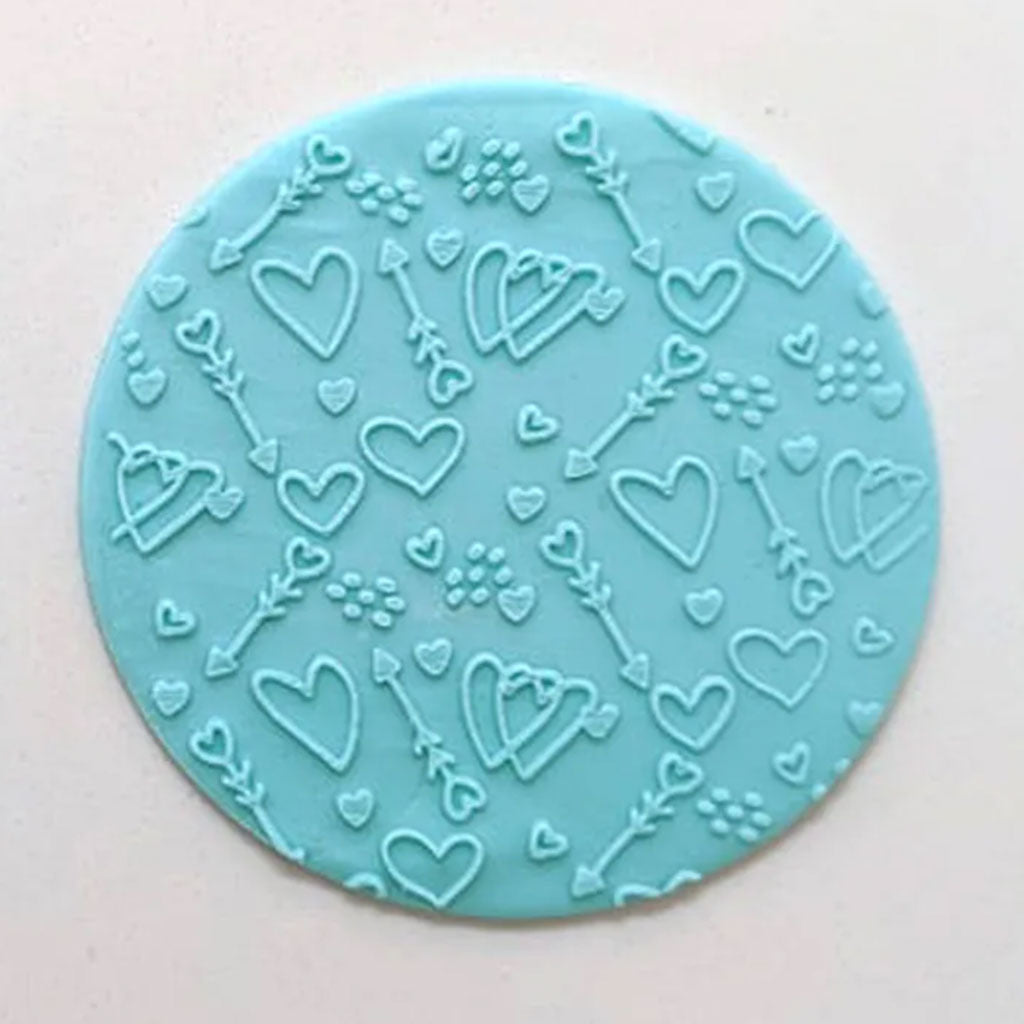 hearts and arrows pattern from debosser on round circle of blue icing