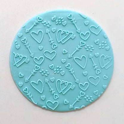 hearts and arrows pattern from debosser on round circle of blue icing