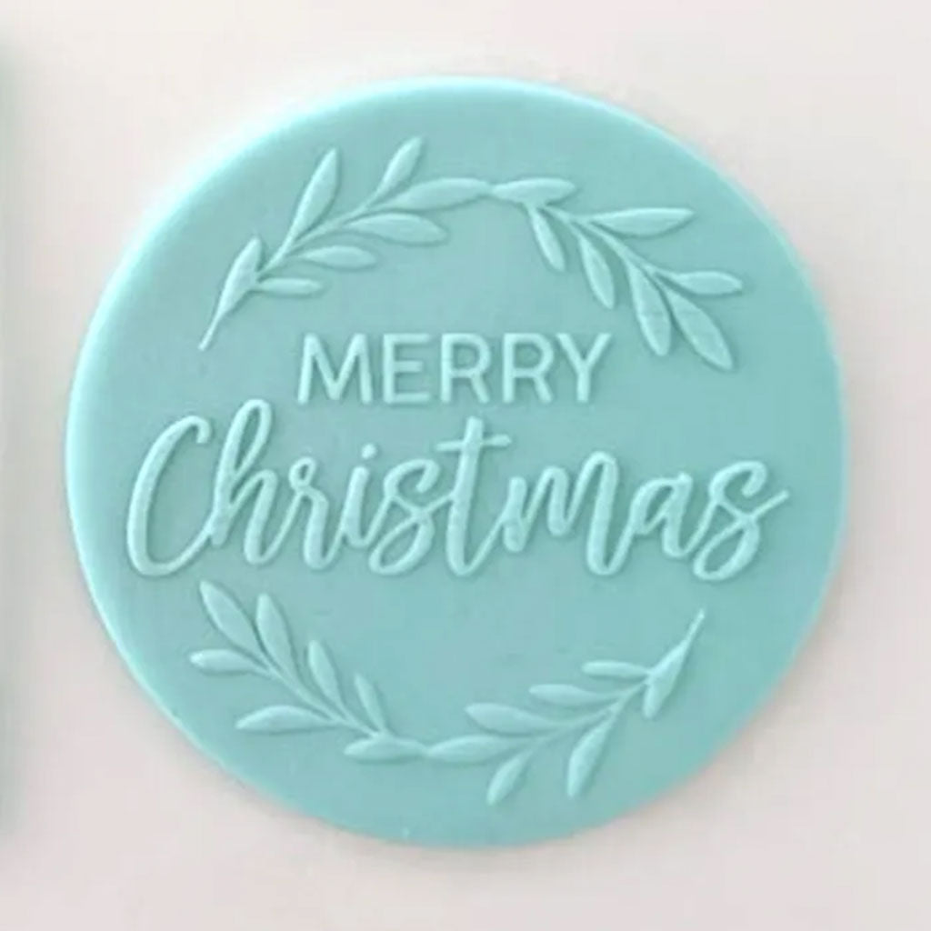 merry Christmas pattern from debosser on round circle of blue icing