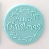 merry Christmas pattern from debosser on round circle of blue icing