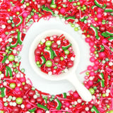 Watermelon (pink, white, red & green)sprinkle mix surrounding spoonful of sprinkles in centre